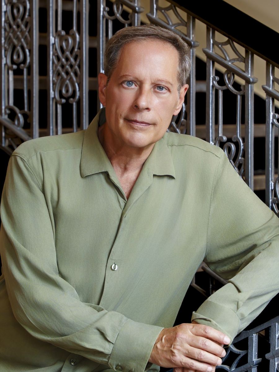 Portrait of Michael Lewin wearing a green shirt