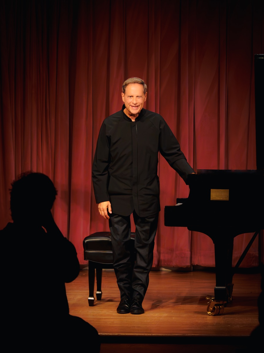 Michael Lewin standing onstage after a recital
